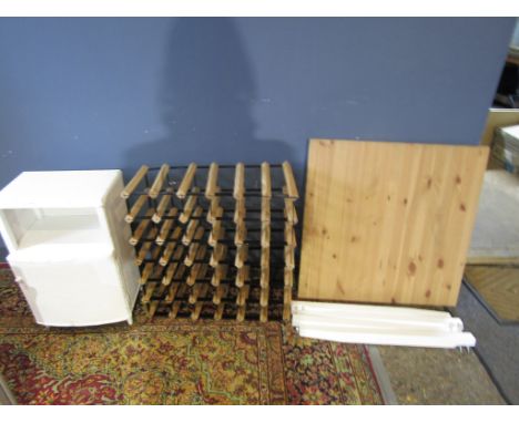 A square Ikea table, a wine rack and Lloyd Loom style bedside&nbsp;