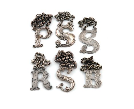 A collection of Scottish antique silver 'Cut-out' letter wine labels, various dates and makers, comprising: one by James Howd