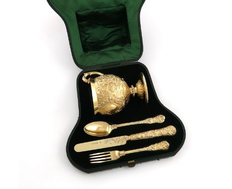 A cased Victorian silver-gilt matched four piece christening set, by George Adams, London 1866-1869, comprising: a cup of cir