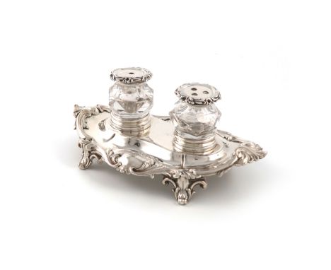 A small Victorian silver inkstand, by The Barnards, London 1845, shaped oval form, foliate borders, on four scroll bracket fe