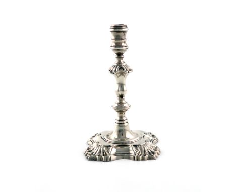 A George II silver taper stick, by William Gould, London 1751, knopped stem, shell shoulder, on a shaped square base with she