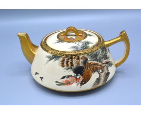 A 19th Century Japanese Satsuma Teapot with hand painted and gilded decoration depicting a bird of prey, marks to base, 8 cms