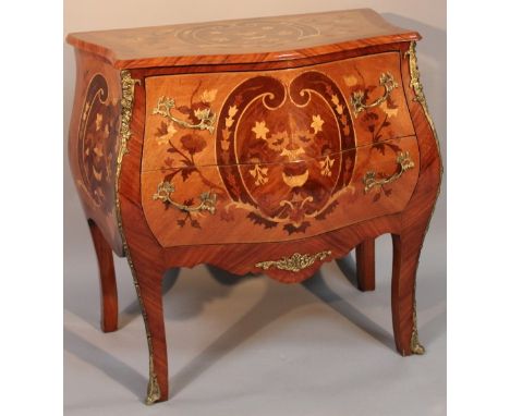 A French Louis XV style commode, of bombe serpentine form, and parquetry top above two drawers with full ormolu mounts on sab