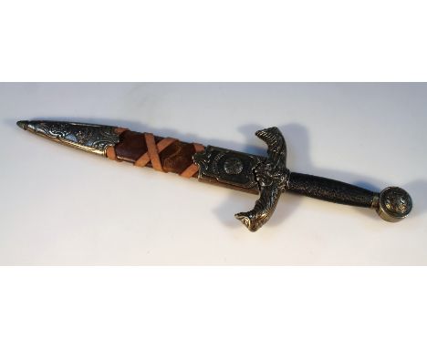 A replica dagger and scabbard, of typical form with leatherette casing and turned handle with metal mounts and bird's head gr