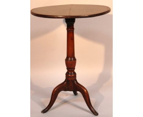 An 18thC oak tripod table, with a circular top raised above a baluster column terminating in triple cabriole supports, 53cm d