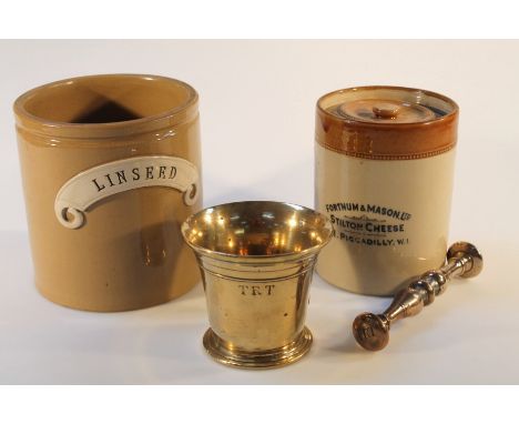 An early 19thC brass pestle and mortar, of typical form, the cylindrical body engraved with the letters T R T, together with 
