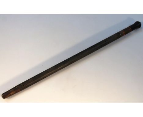 A mid-20thC ebonised carved and part metal swagger stick, of tapering cylindrical form with metal end, possibly African, 59cm