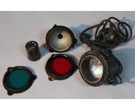 A mid-20thC search light, with a metal casing and shaped hand grip, with wired ends and other accessories, probably WWII, 27c