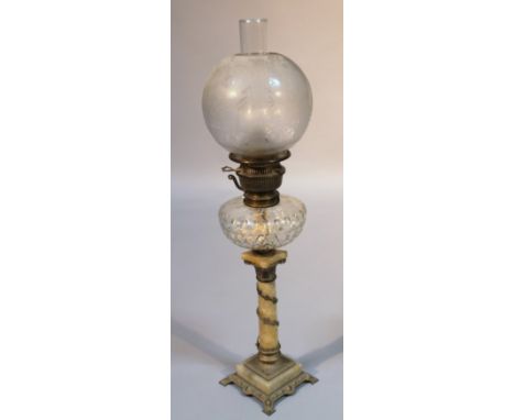 An early 20thC onyx glass and oil lamp, of typical form with a textured glass reservoir raised on a classical stem of circula