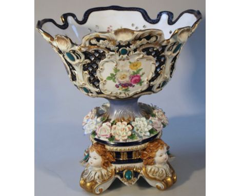 An R K Dresden centrepiece, the shaped part pierced florally decorated bowl raised on a florally encrusted stem terminating i