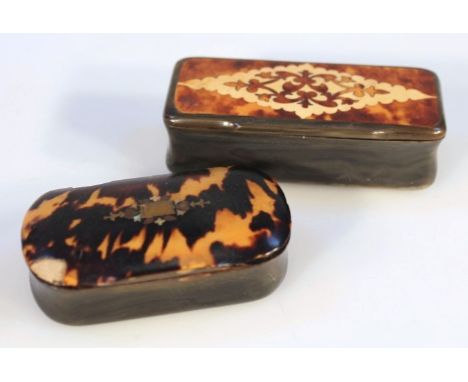 A 19thC tortoiseshell and horn snuff box, of shaped oval form, the hinged lid centred with an elaborate escutcheon, revealing