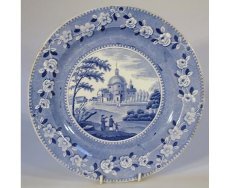An early 19thC Spode blue and white plate, of circular form set with figures before trees and buildings, with an outer oak le