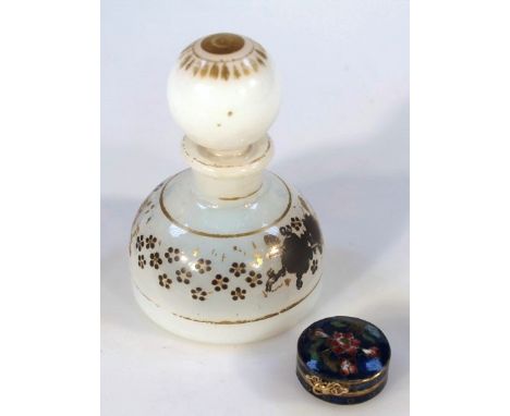 An early 20thC enamel patch box of circular form, the lidded top with an elaborate thumb handle, polychrome decorated in flow