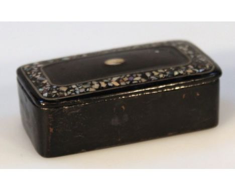 A 19thC papier mache and mother of pearl snuff box, of shaped rectangular form, the hinged lid centred by a plain escutcheon 