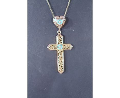 An early 20thC crucifix, with heart shaped finial set with turquoise and seed pearls of part pierced form, attached to a slen