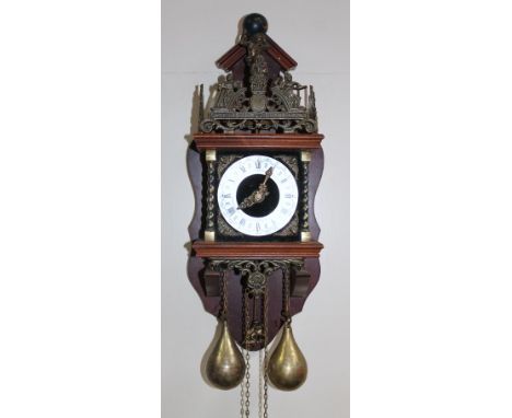 A 20thC hanging wall clock, the galleried upper section centred by a figural finial, above a silvered 14cm dial, set with Rom