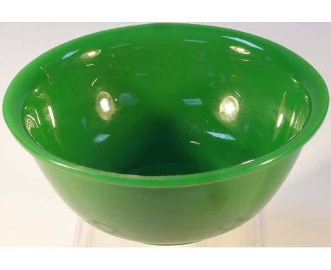 A fine Peking jade-green glass bowl, on turned hardwood stand, 17cm dia. x 7.5cm high.