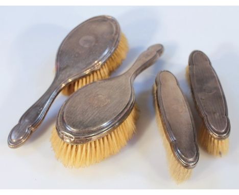 A George V silver four piece dressing table set, by B & Co, comprising two clothes brushes and two hair brushes, 25cm wide, e