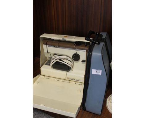 A FRISSER & ROSSMAN SEWING MACHINE & A TYPEWRITER