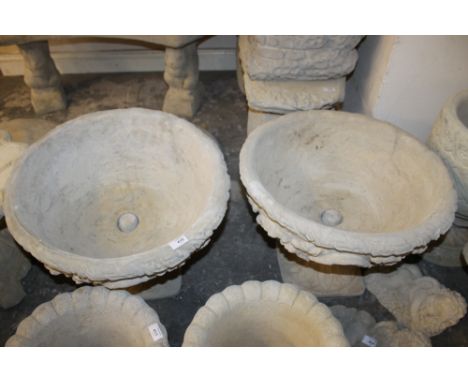 TWO LARGE STONE URN PLANTERS DECORATED WITH ACANTHUS LEAVES