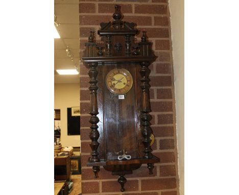 A 19TH CENTURY VIENNA WALL CLOCK WITH PENDULUM