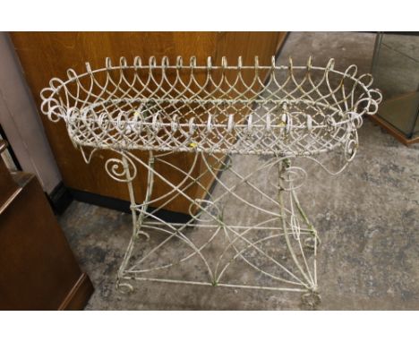 AN ANTIQUE WIREWORK FLOORSTANDING PLANT TROUGH