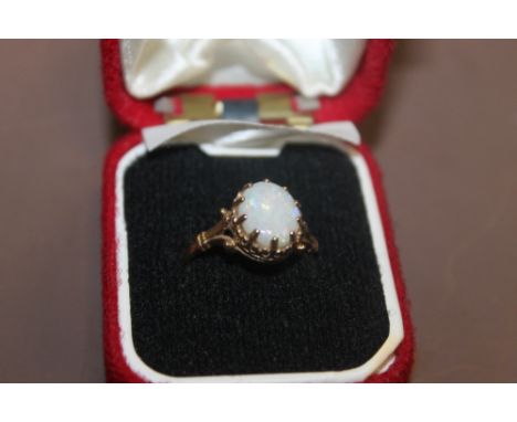 A 9CT GOLD LADIES DRESS RING SET WITH AN OPAL