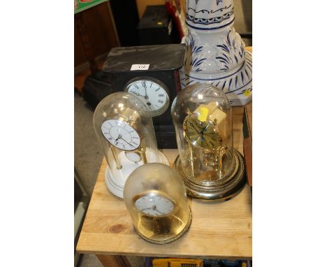 A SMALL SLATE MANTLE CLOCK TOGETHER WITH THREE GLASS DOMED MANTLE CLOCKS