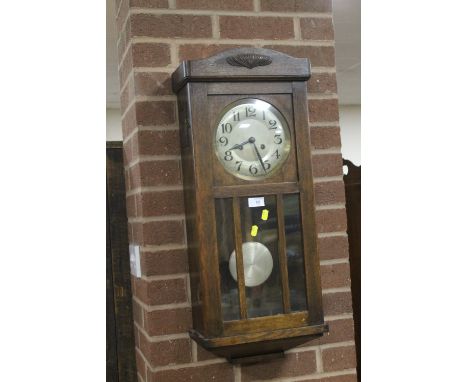AN OAK WALL CLOCK