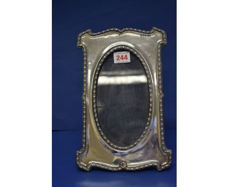 An Edwardian silver photograph frame, by M & C, Birmingham 1906, 26.5cm x 17cm.