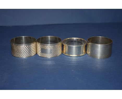 A pair of engine turned silver napkin rings, by R & D, Birmingham 1947; together with two others, 94g.