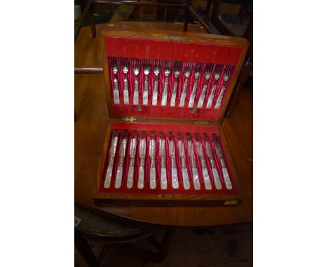 A Victorian oak cased set of twelve EPNS tea knives and forks having mother of pearl handles.