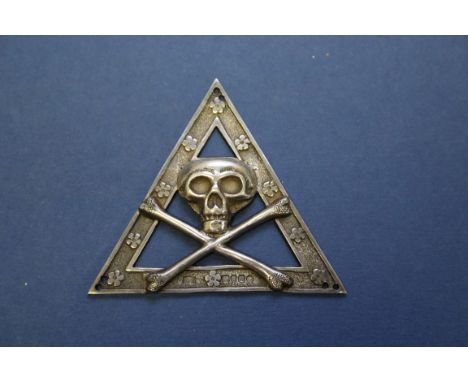 A Victorian silver Masonic badge, by R S, London 1867, decorated central skull and cross bones, 6.6cm, 22g.