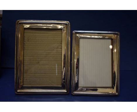 Two vintage silver rectangular photograph frames.