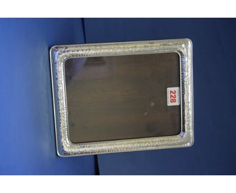 A modern hammered silver photograph frame, 23.5 x 18.5cm.