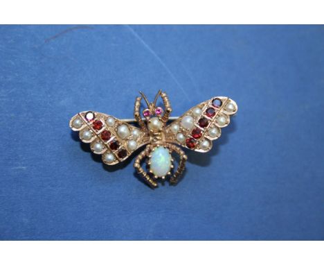 An opal, ruby and seed pearl set butterfly, mounted in yellow metal.