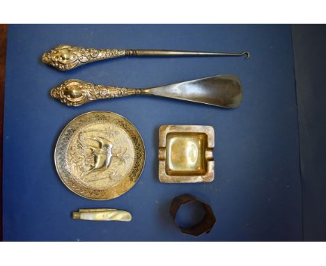 A silver handled button hook and matching shoehorn; together with a silver pin dish; a foreign metal dish; and a fruit knife 