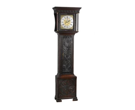 A carved oak longcase clock, with eight-day bell striking movement, the 12inch brass dial with applied spandrels to the angle