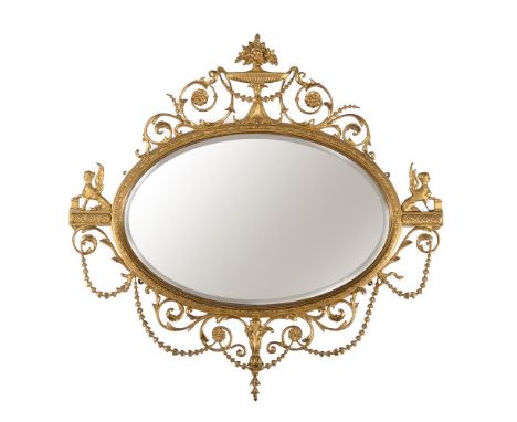 A giltwood and composition oval wall mirror, 20th century, after the manner of Robert Adam, with flanking winged sphinges, 11