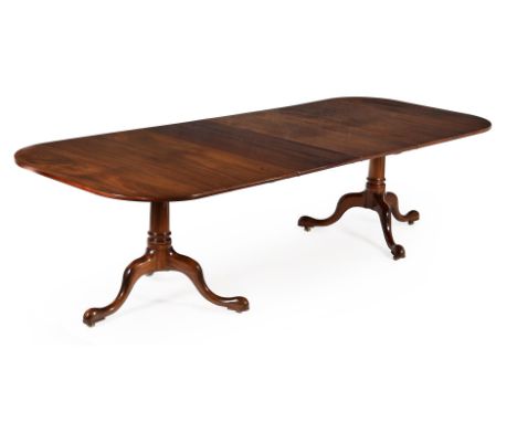 A mahogany twin pedestal dining table in George III style, 20th century, by William Tillman, with two additional leaf inserti