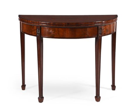 A George III mahogany and crossbanded folding demi-lune card table, circa 1790, in the manner of Ince & Mayhew, the hinged to