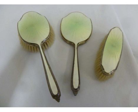 A three piece silver and enamel dressing set
