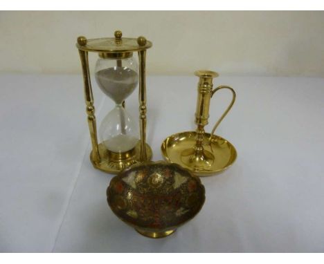 Brass and glass sand timer, a brass chamber stick and an enamel dish