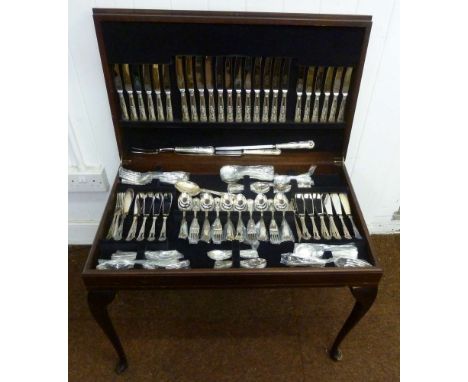 A canteen of Kings pattern silver plated flatware for twelve people in fitted leather top table on four cabriole legs