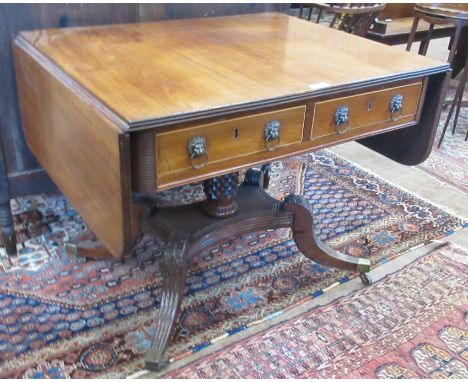 An early 19th Century mahogany Sofa Table fitted two frieze drawers with pineapple carved column and quadruple supports, with