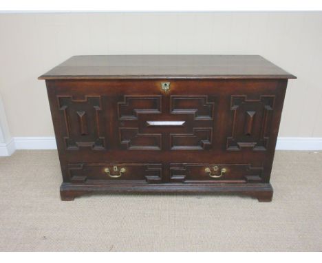 An antique oak Mule Chest with hinged top, panelled front above two panelled drawers on bracket supports, 4ft 3in W