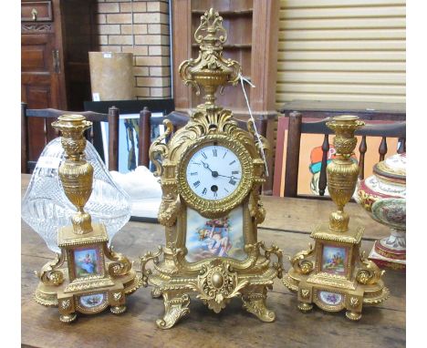 A late 19th Century French gilt metal and porcelain mounted matched Clock Garniture, the circular 3in enamel dial with black 