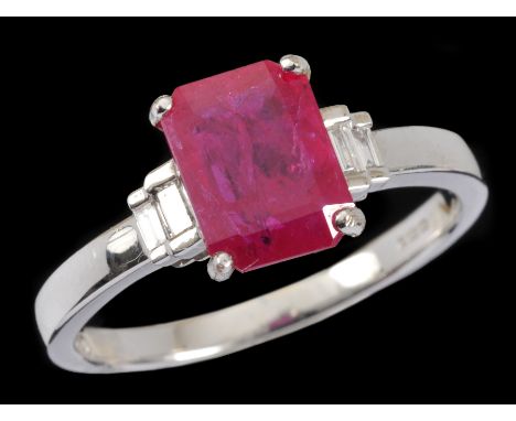 A Ruby and Diamond Ring corner claw-set step-cut ruby, 1.40cts, between two pairs of channel-set baguette diamonds in 18ct wh