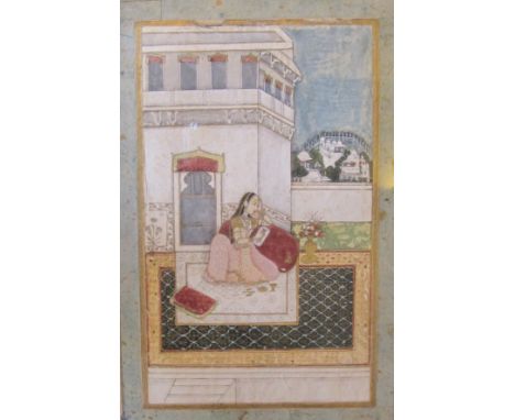 PROVINCIAL MUGHAL, NORTHERN INDIA, LATE 18th CENTURY'Dhanashri ragini'- a woman painting a portrait of her lover, seated on a