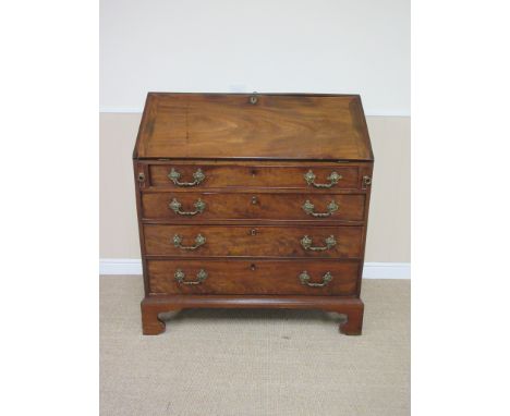 A George III mahogany Bureau with well, fitted interior having central small mirror door flanked by pair of fluted column fro